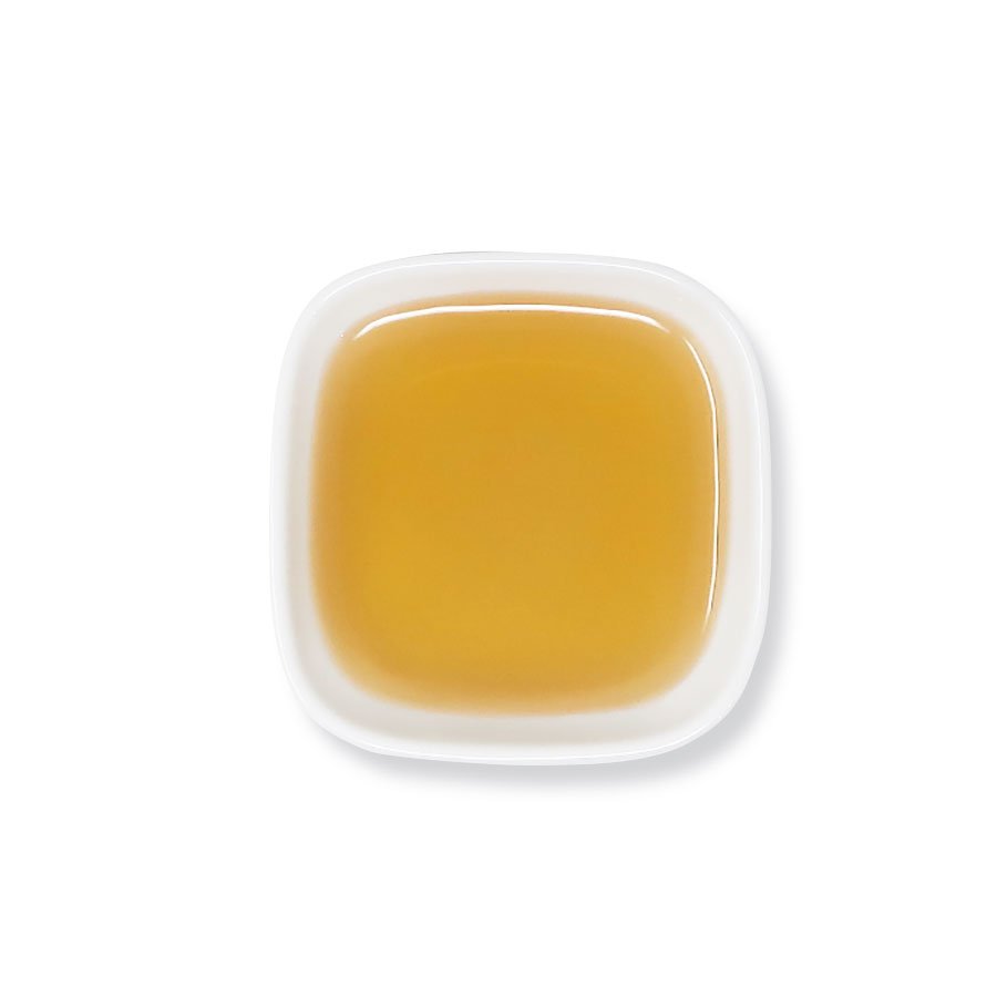 Top view of kumquat lemon syrup with rich golden tone and smooth texture.