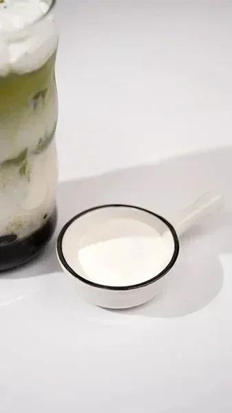 White specialty powder in a glass container — used for slushy mixes, ice cream bases, and non-dairy creamer