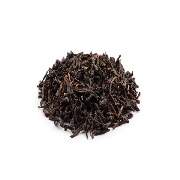 Dried Assam black tea leaves with twisted shape and dark reddish-brown tone.