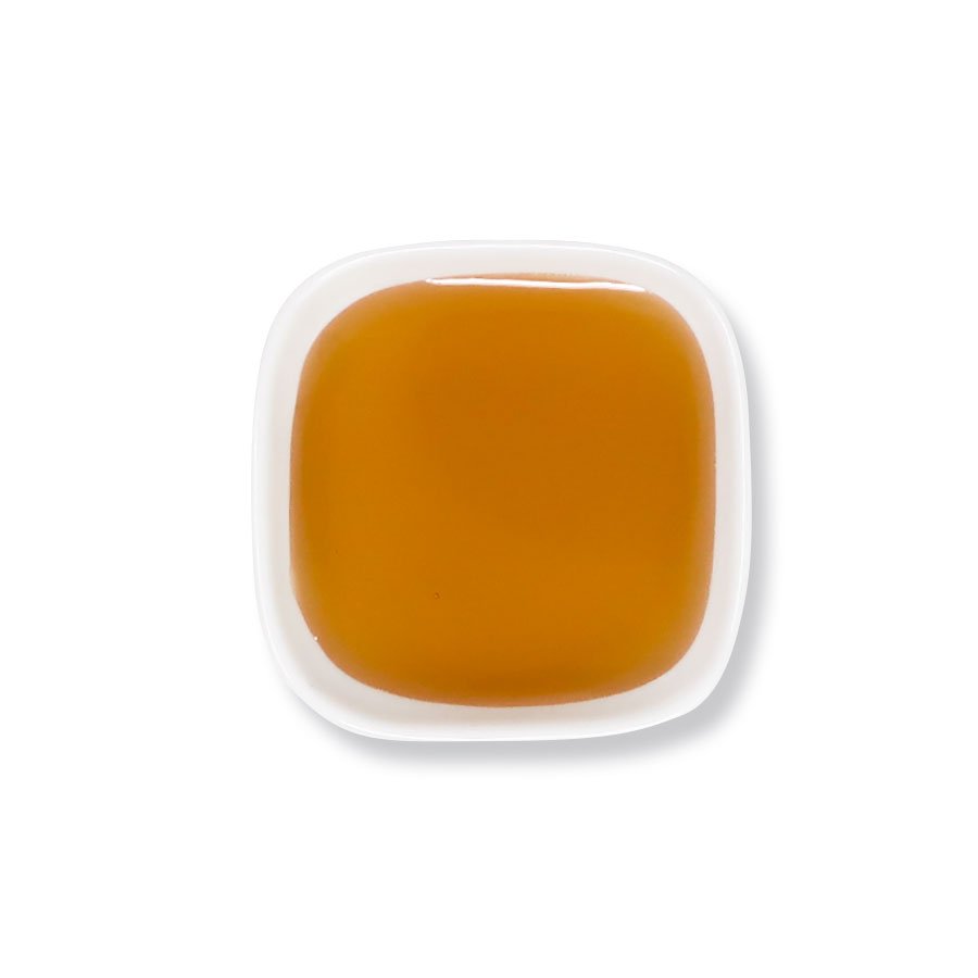 Top view of longan honey syrup – glossy and smooth golden texture.