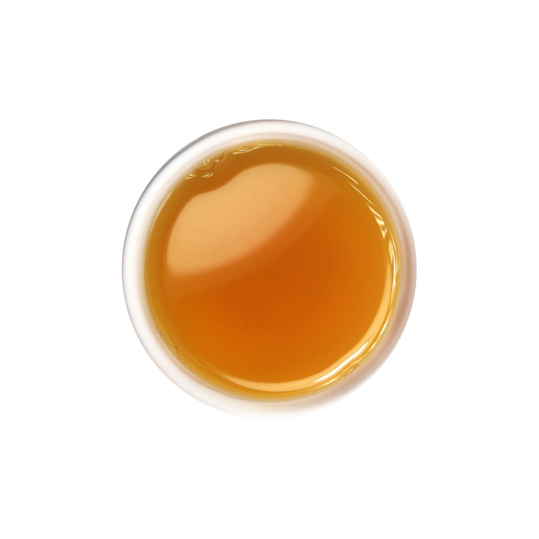 Brewed Dong Ding oolong tea with honey-brown hue and rich aroma.