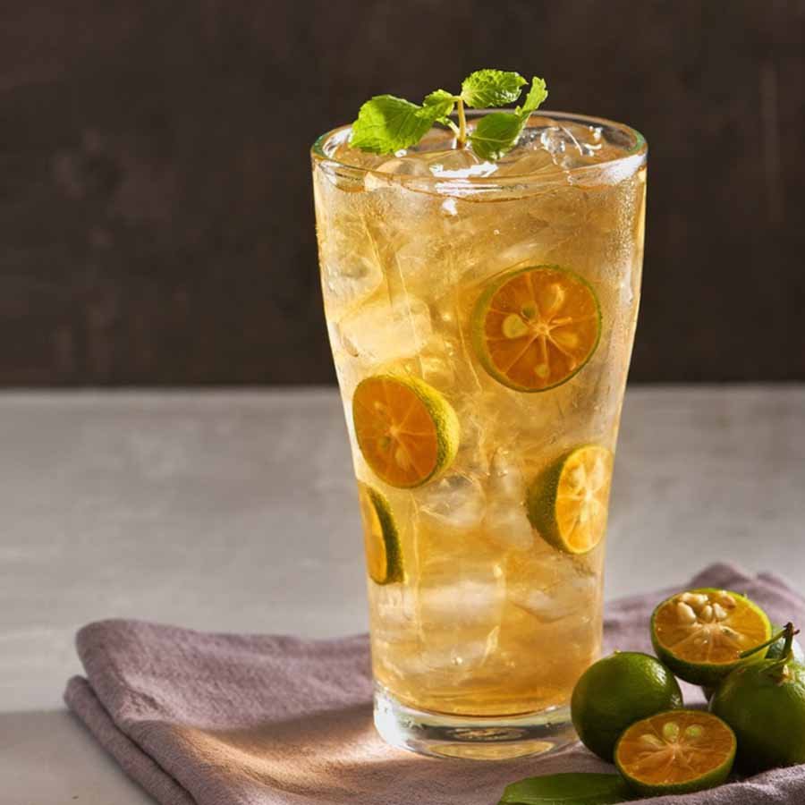 Iced tea made with kumquat lemon syrup, garnished with citrus slices – tangy, cooling, and refreshing.