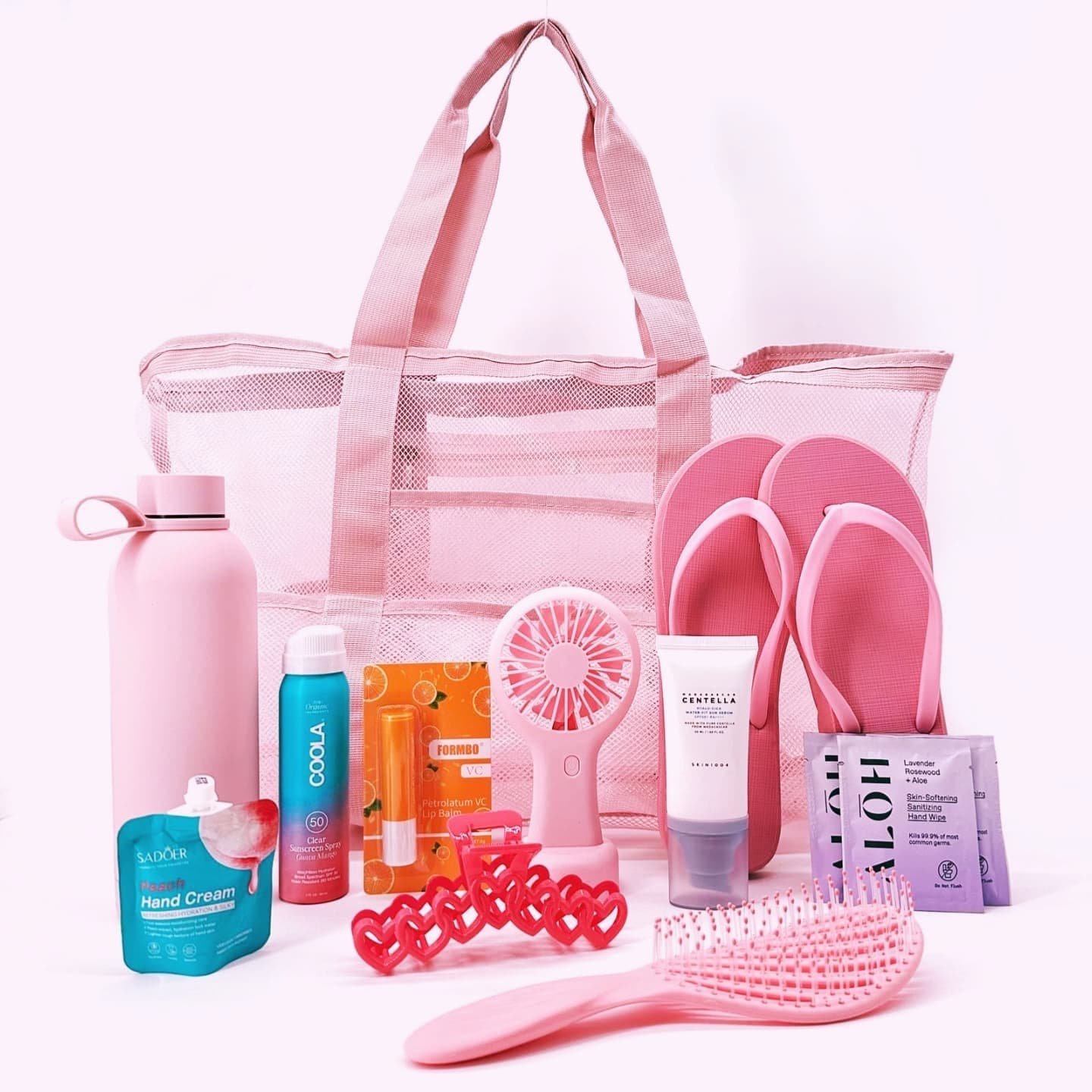 Dive into your perfect beach day with the Pink Sands Beach Day Kit! This essential set is packed with everything you need for sun-soaked relaxation and refreshing moments. Includes mesh tote bag, large enough to carry all your essentials. Chic water