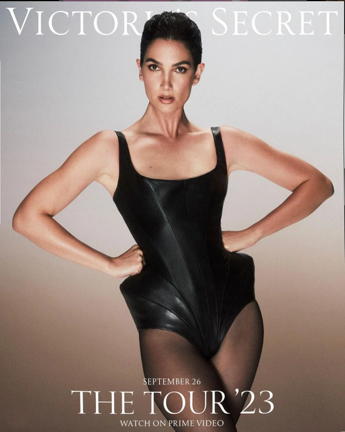 Victoria's Secret advertisement featuring a woman in black leather bodysuit and sheer black tights, with hands on hips, promoting 'The Tour '23' starting September 26, available on Prime Video. Custom leather bodysuit made at whae studio