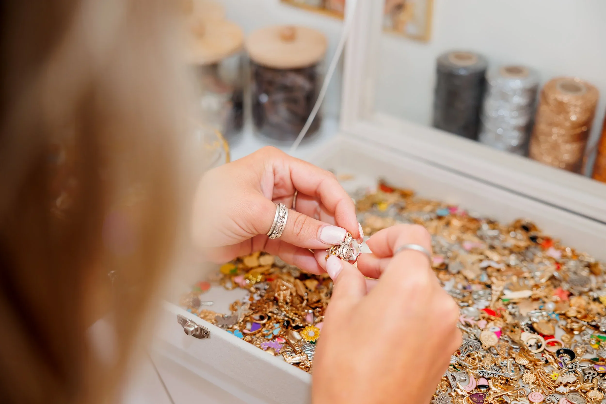 a woman holding the charms of jewely