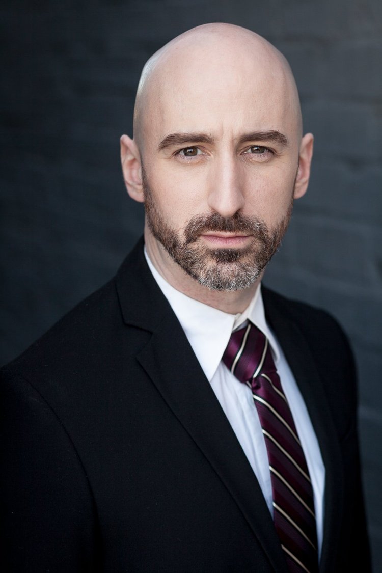 Austin corporate portrait against a dark background