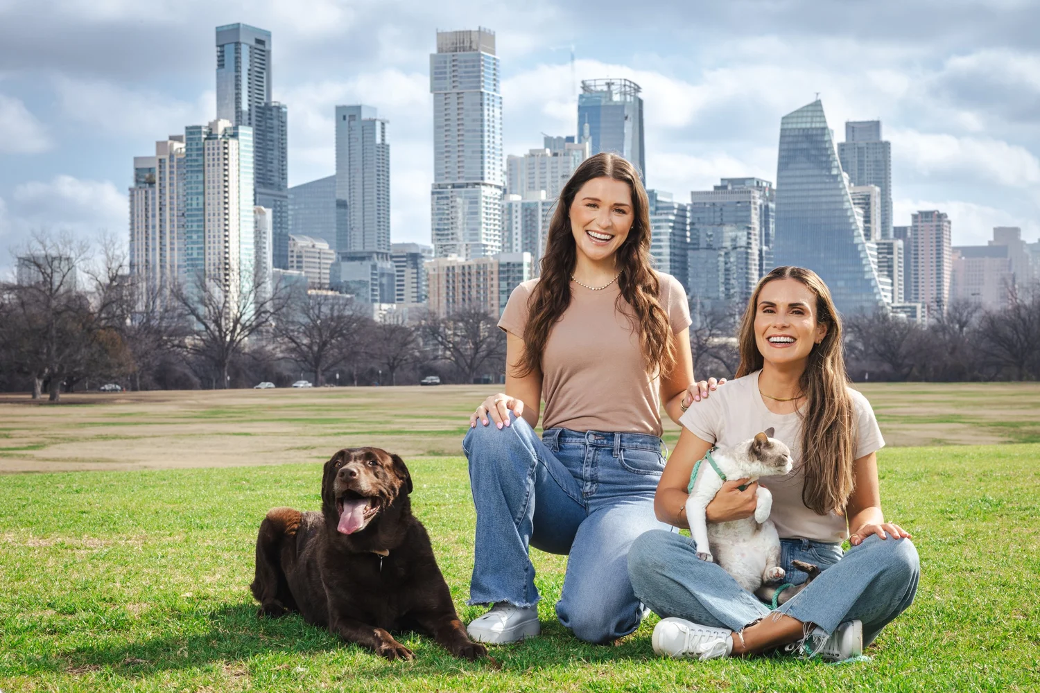 Founders of Evolved Vets with their dogs in Zilker Park and the Austin skyline