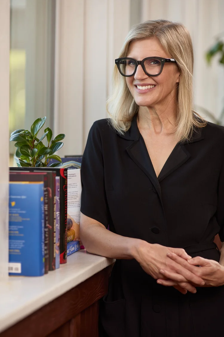 Environmental portrait of a Starling Literary team member beside books and a window