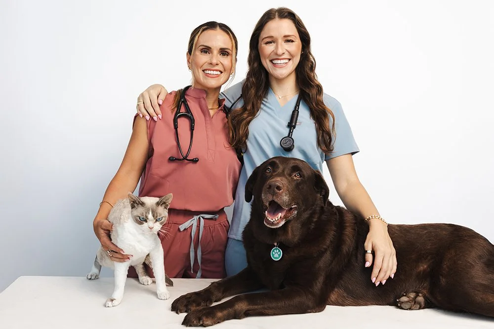 Two veterinarians with a cat and dog during their Austin branding session