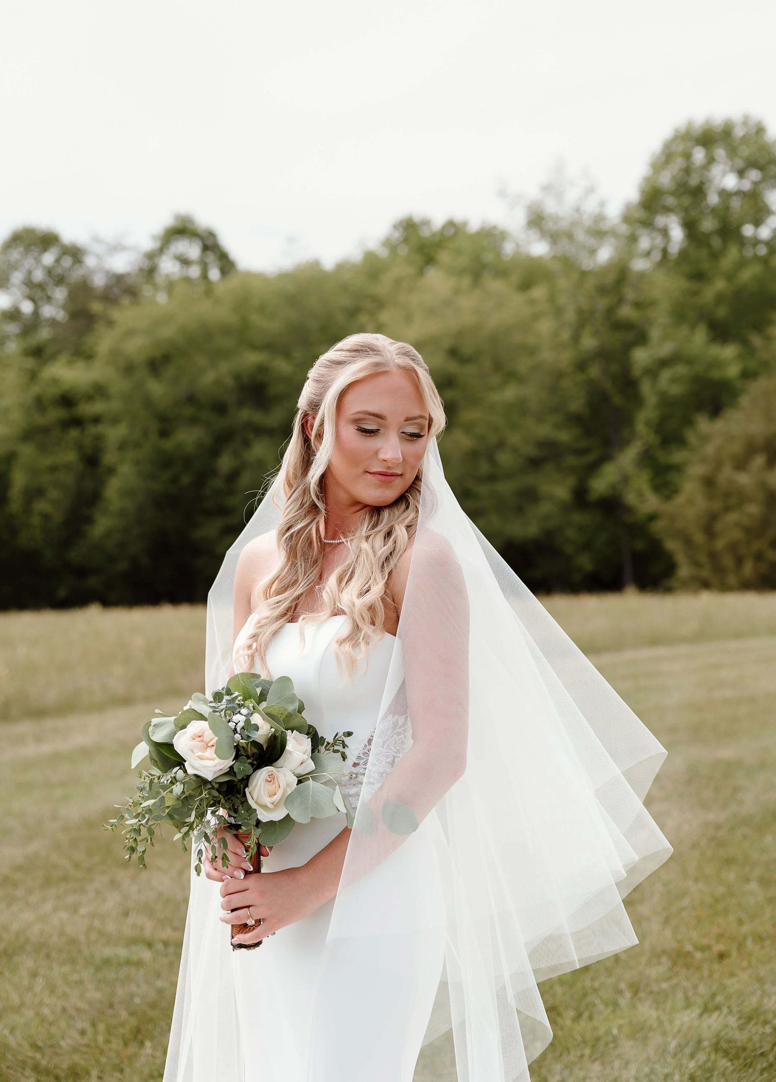 A bride with a bouquet looking over her left shoulder