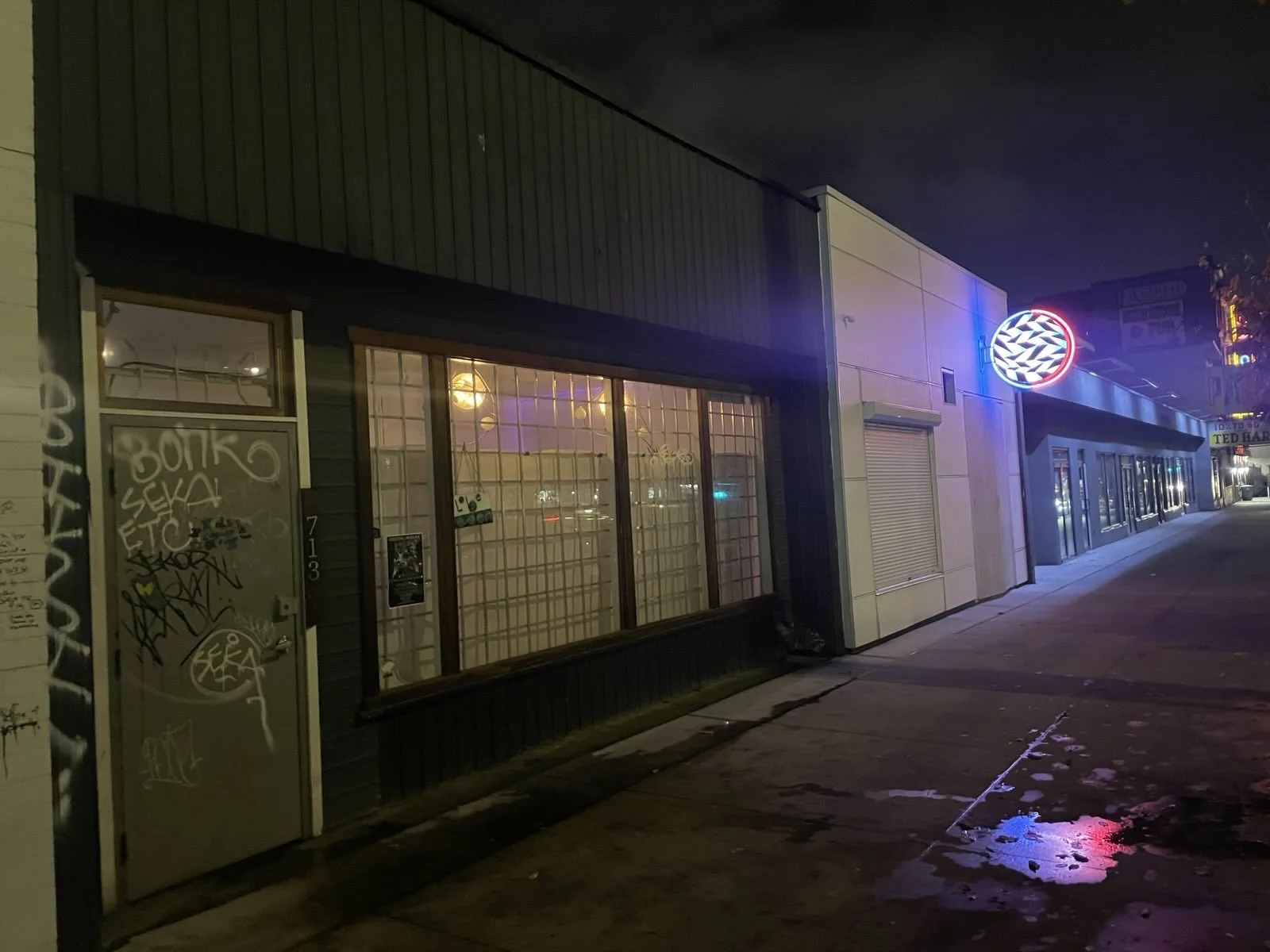 Building exterior from street at nighttime.