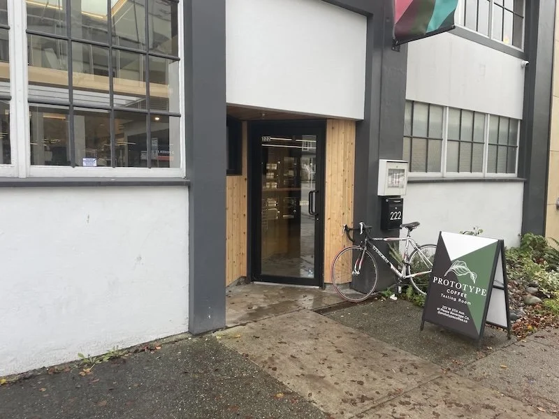 Cafe exterior with bike, glass door.