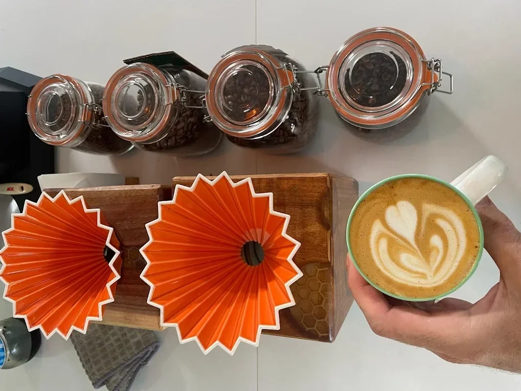 Display of coffee beans and a cute cappuccino.