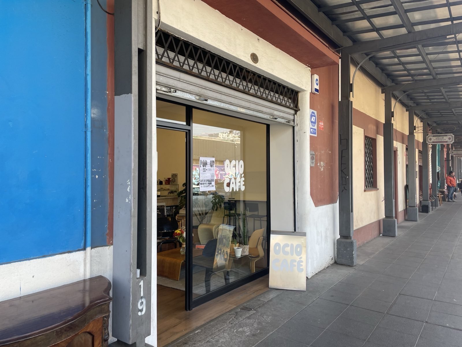 Hip cafe glass exterior with white lettering.
