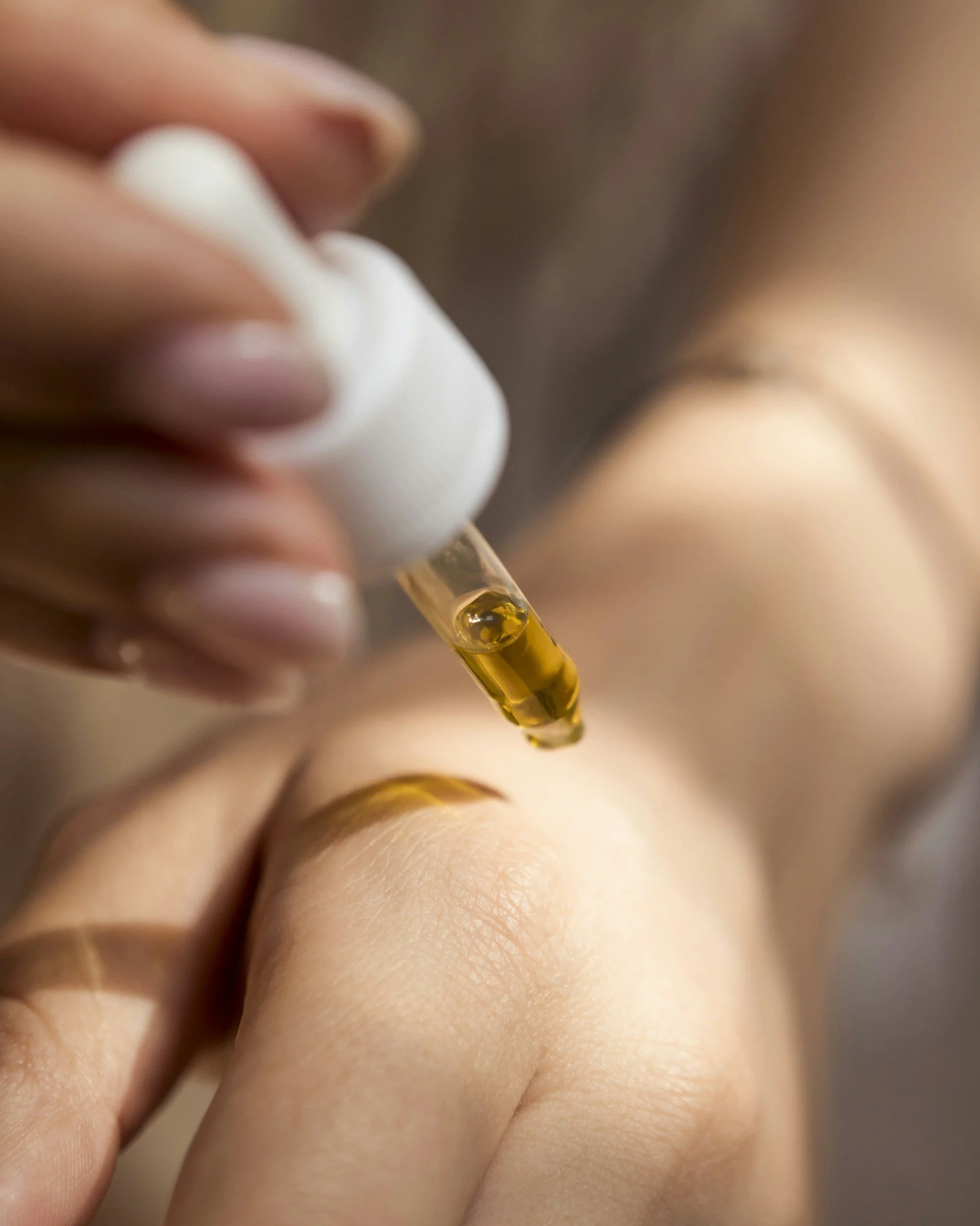 A person applying a vitamin C Serum to their hand