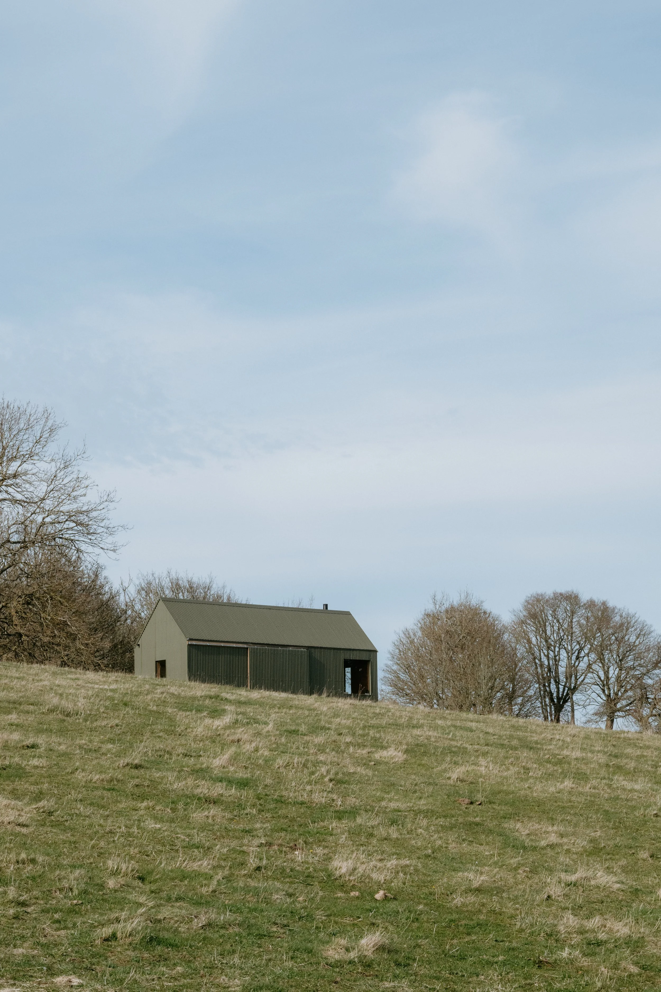 A green wriggly tin clad hilltop cabin, surrounded by nature and rolling meadows. Situated next to the abandoned village of Pitmiddle. 