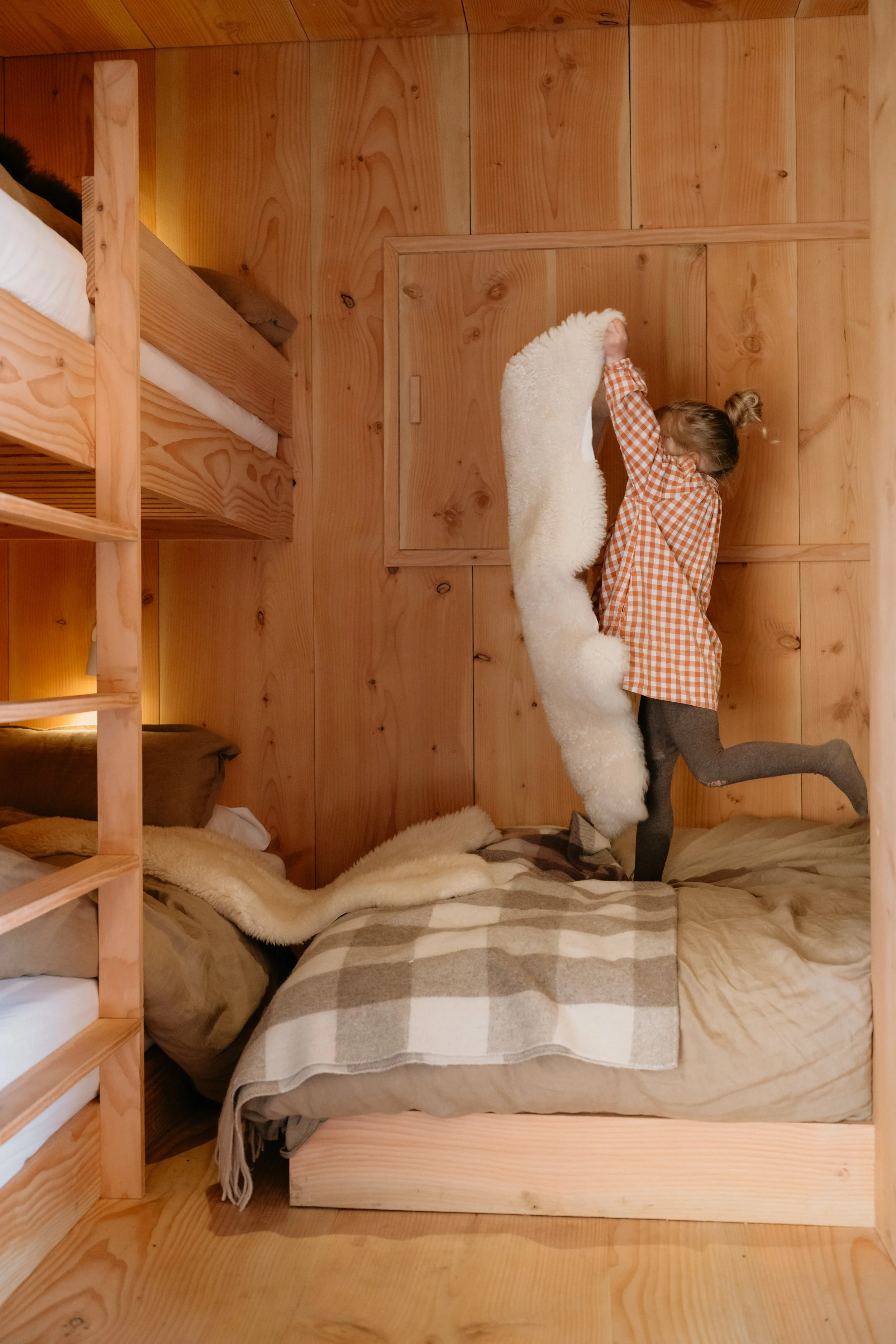 Cosy bunk beds with warm blankets and sheepskins, perfect for families with children who wish to escape the modern digital world. 