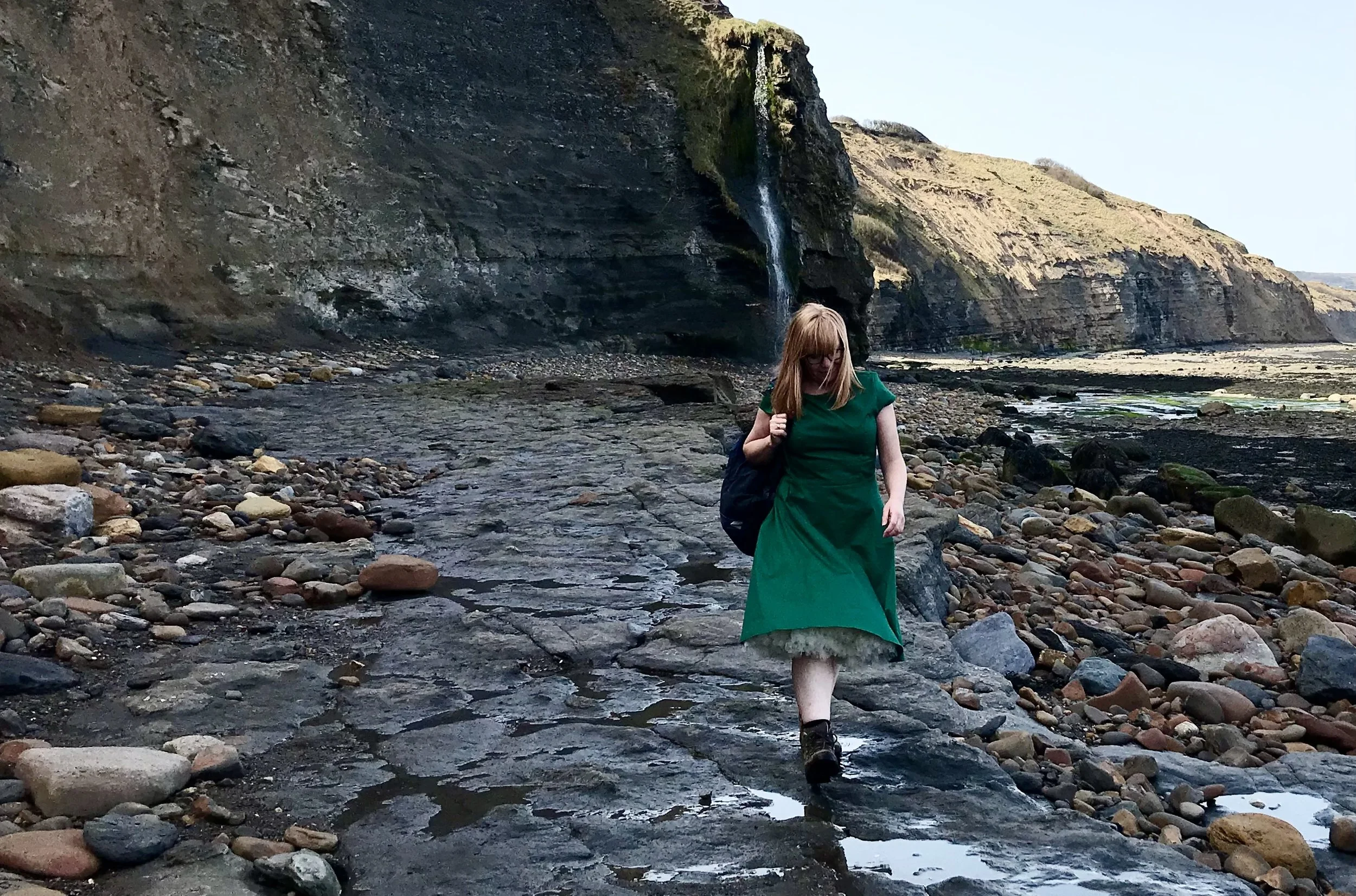 Claire strolls along a beach in Ravenscar.