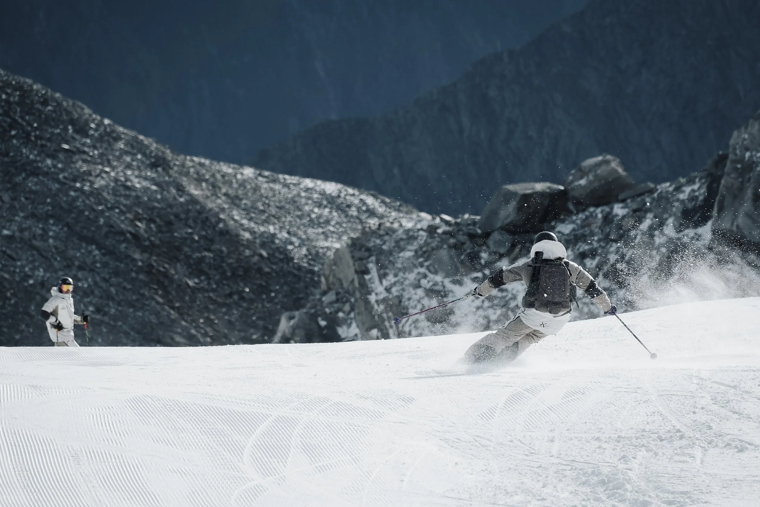 Skier carving a turn on a snow-covered mountain slope.jpg