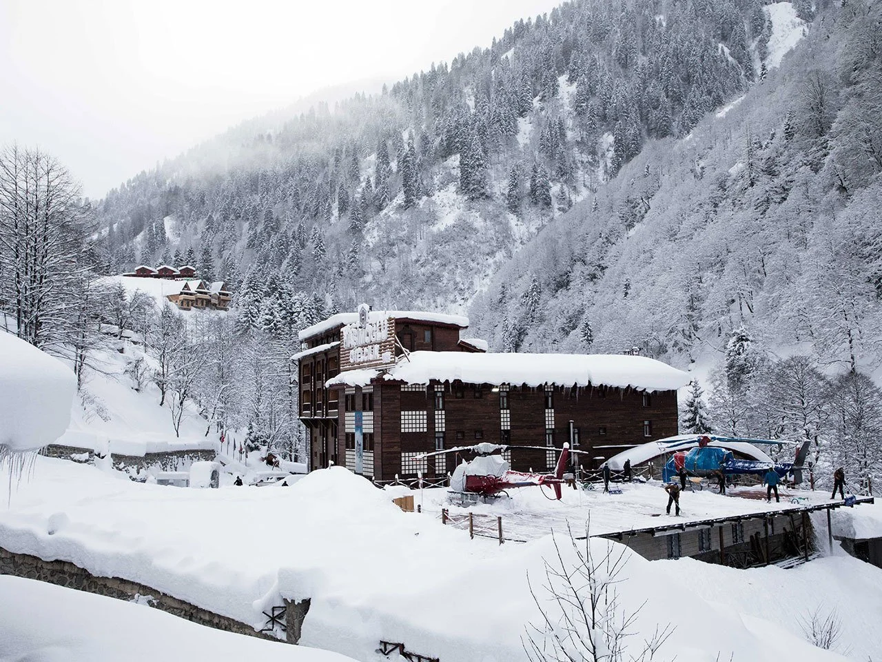 Snow-covered mountain hotel and helipad in Ayder, Turkey