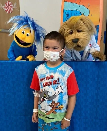 Gizmo and Messy visiting a young patient at Joe DiMaggio Children's Hospital