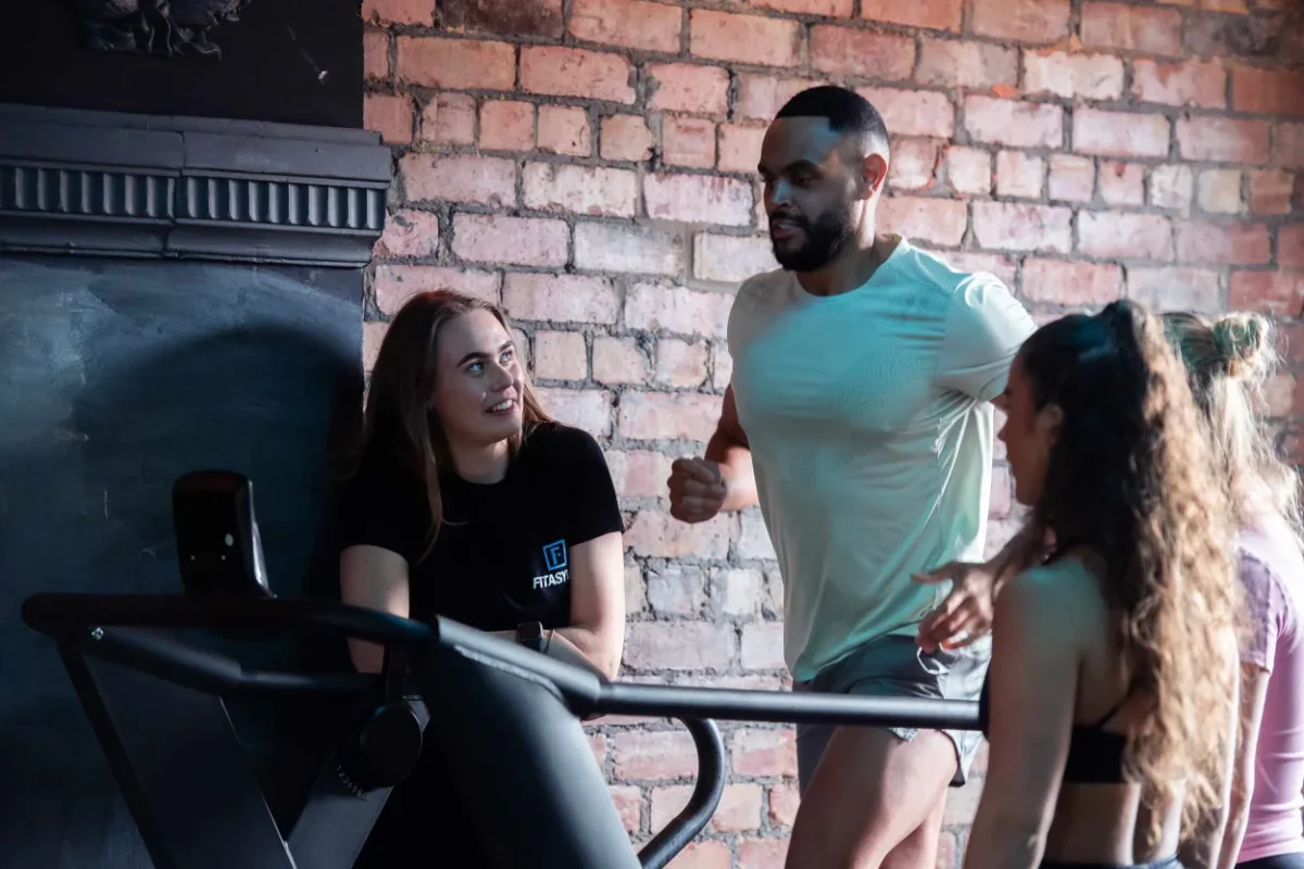 A fitasylum personal trainer monitoring a client