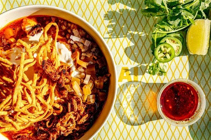 Khao Soi is finally back just in time for a 70&deg; weekend! 

Rich curry broth, pulled chicken, house fermented mustard greens, egg noddles &amp; lots of crunchy things. Served with chili oil on the side so all can enjoy :) 

Perfect patio weather, 