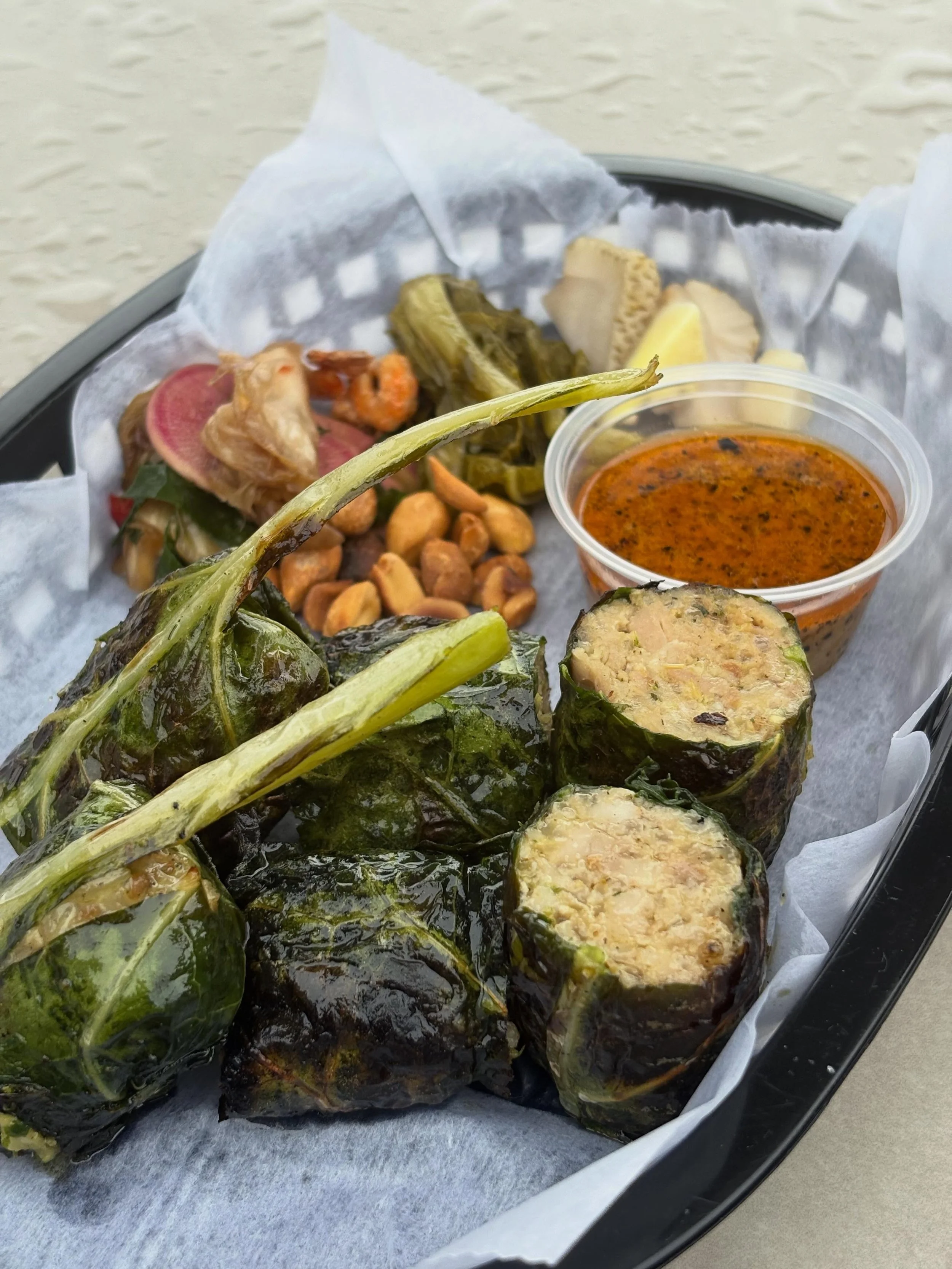 One of my favorite dishes that we have done at the chicken house. Today we bring it back with lots of fun snacky things from our larder. Housemade Thai style chicken sausage that gets wrapped in @growingtogetherfarmersmarket collard greens, poached i