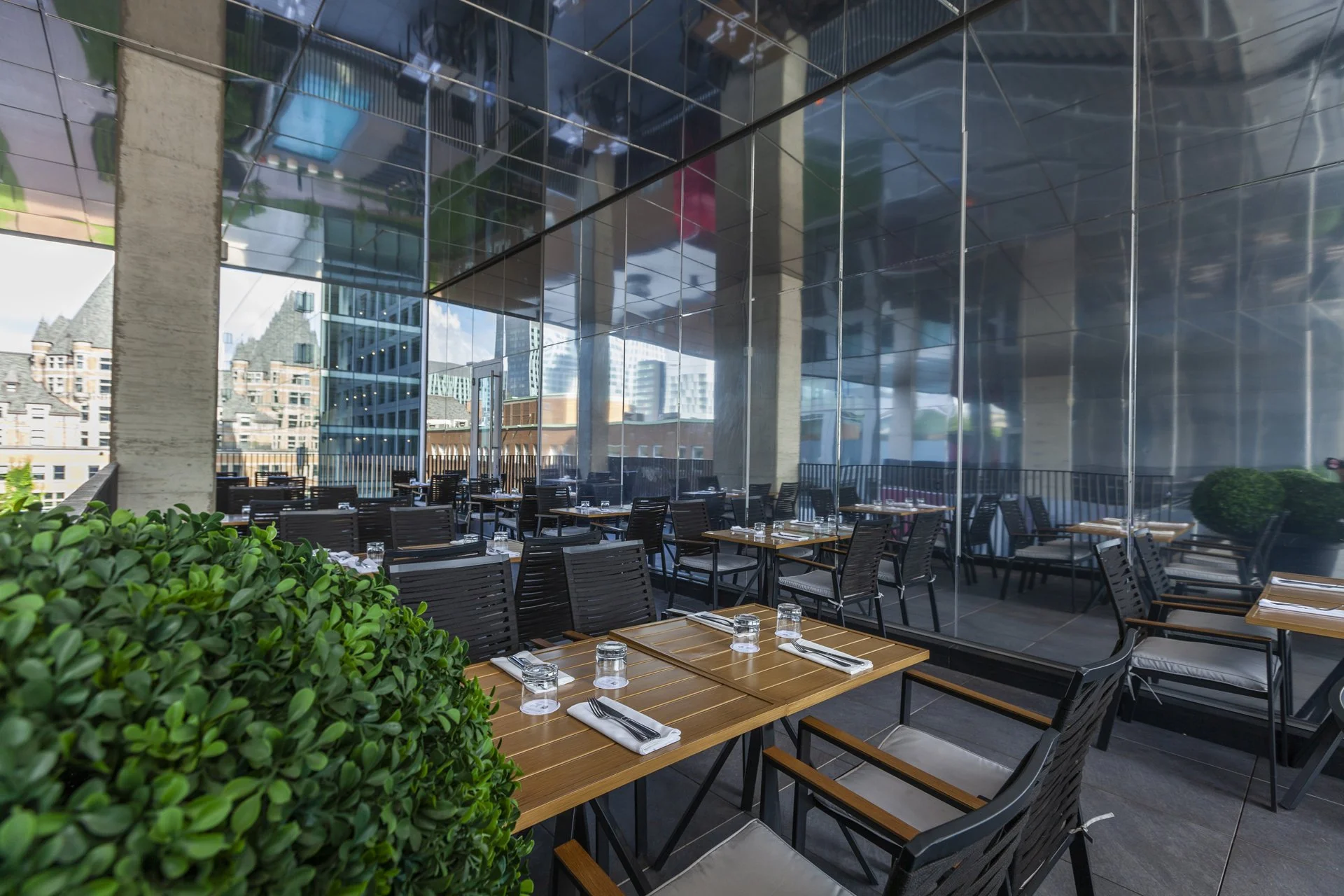 Outdoor terrace seating with views of Castle Viger and Old Montreal architecture at a British pub Montreal, offering a unique Montreal restaurant Old Montreal experience with a vibrant Montreal local atmosphere.