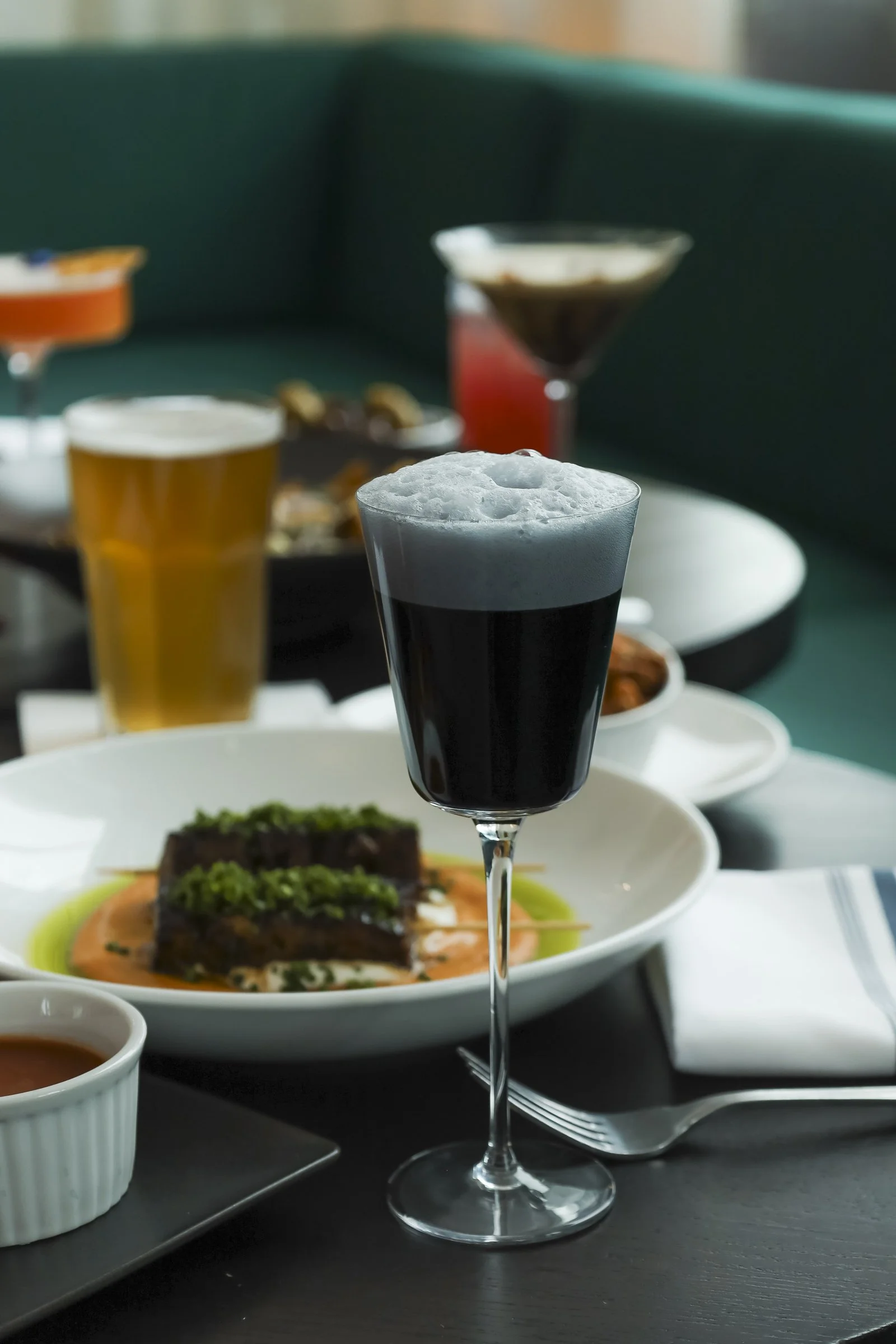 Craft cocktails and draft beer served with shareable plates at a British pub Montreal in Old Montreal, highlighting the lively Montreal bar atmosphere and authentic Old Montreal pub dining experience.