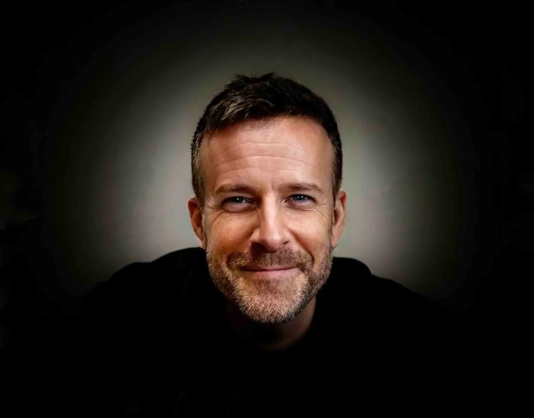 Steve Gouws smiling with dark circle behind