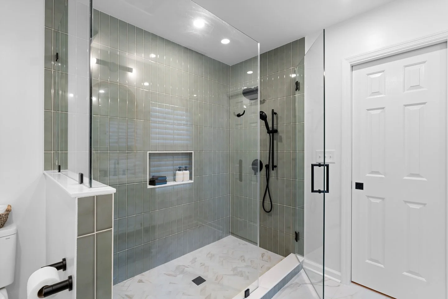 Sleek, serene, and built to last &mdash; this custom shower by Canter Construction combines timeless design with modern function. From the handcrafted vertical tile to the matte black fixtures and spacious glass enclosure, every detail was designed t