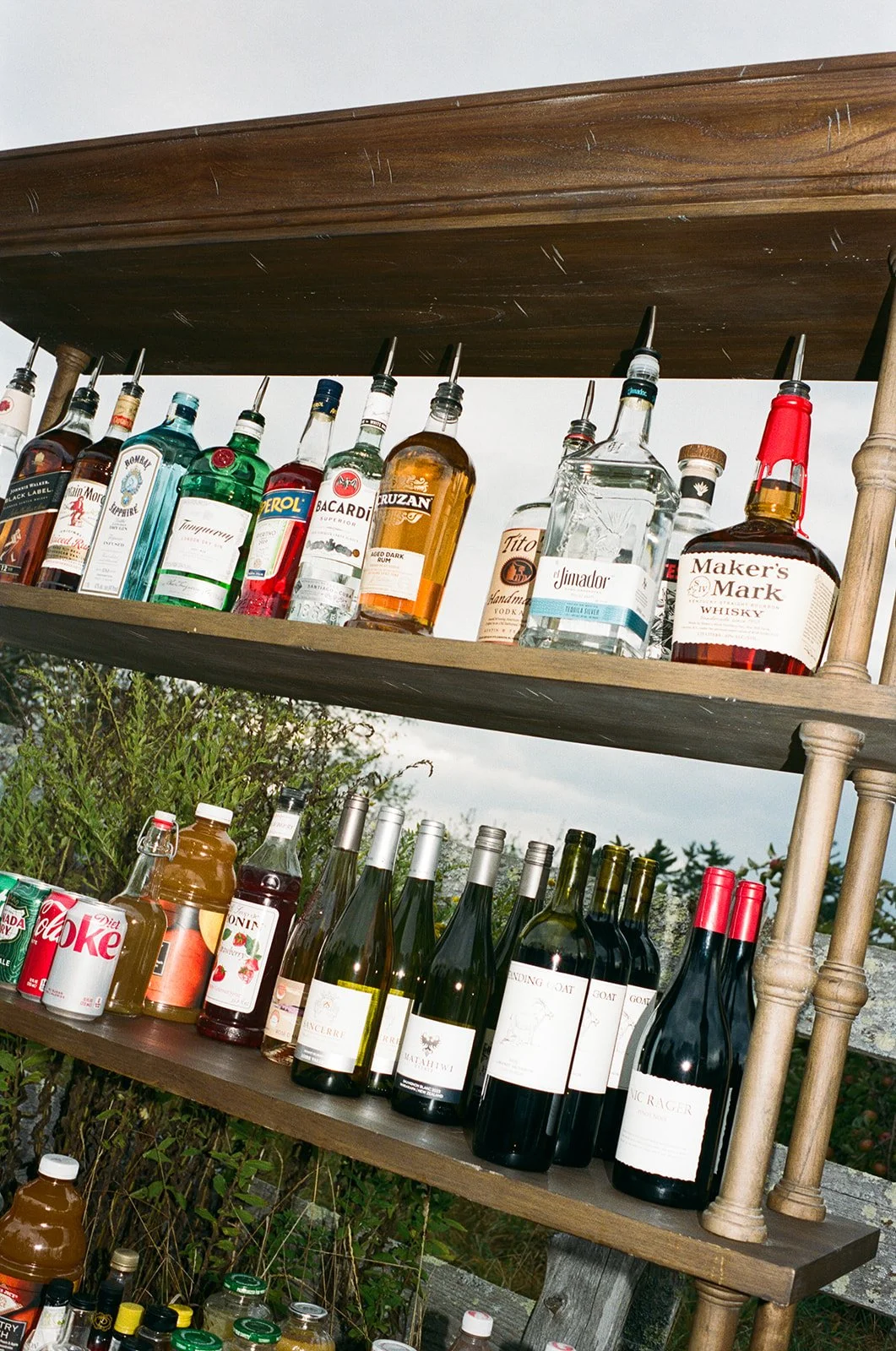 Full bar display by Eido Bar Company featuring a wide selection of liquor options at a wedding reception.
