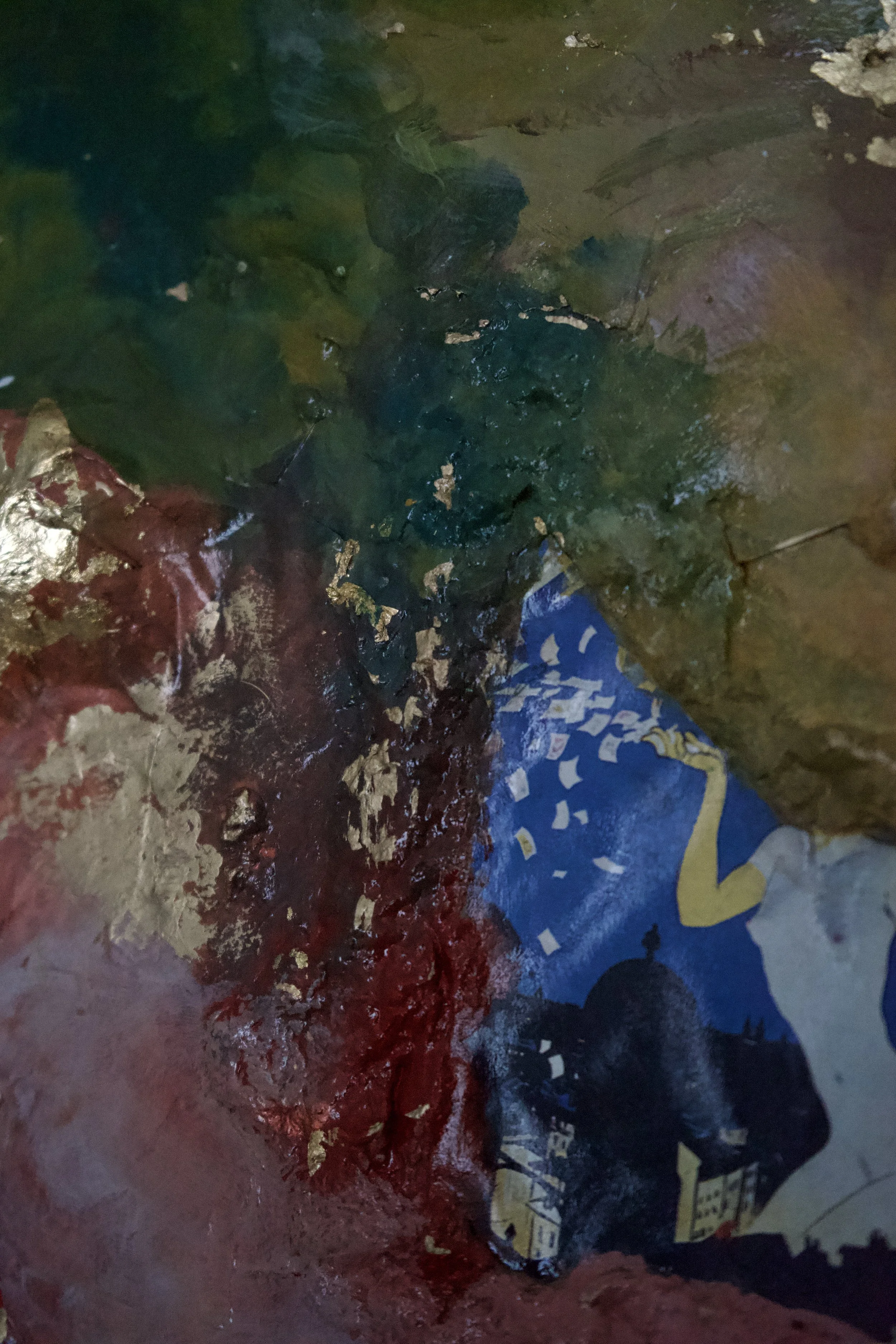 Close-up of crushed, colorful packaging material with some shredded paper and areas of shiny foil.