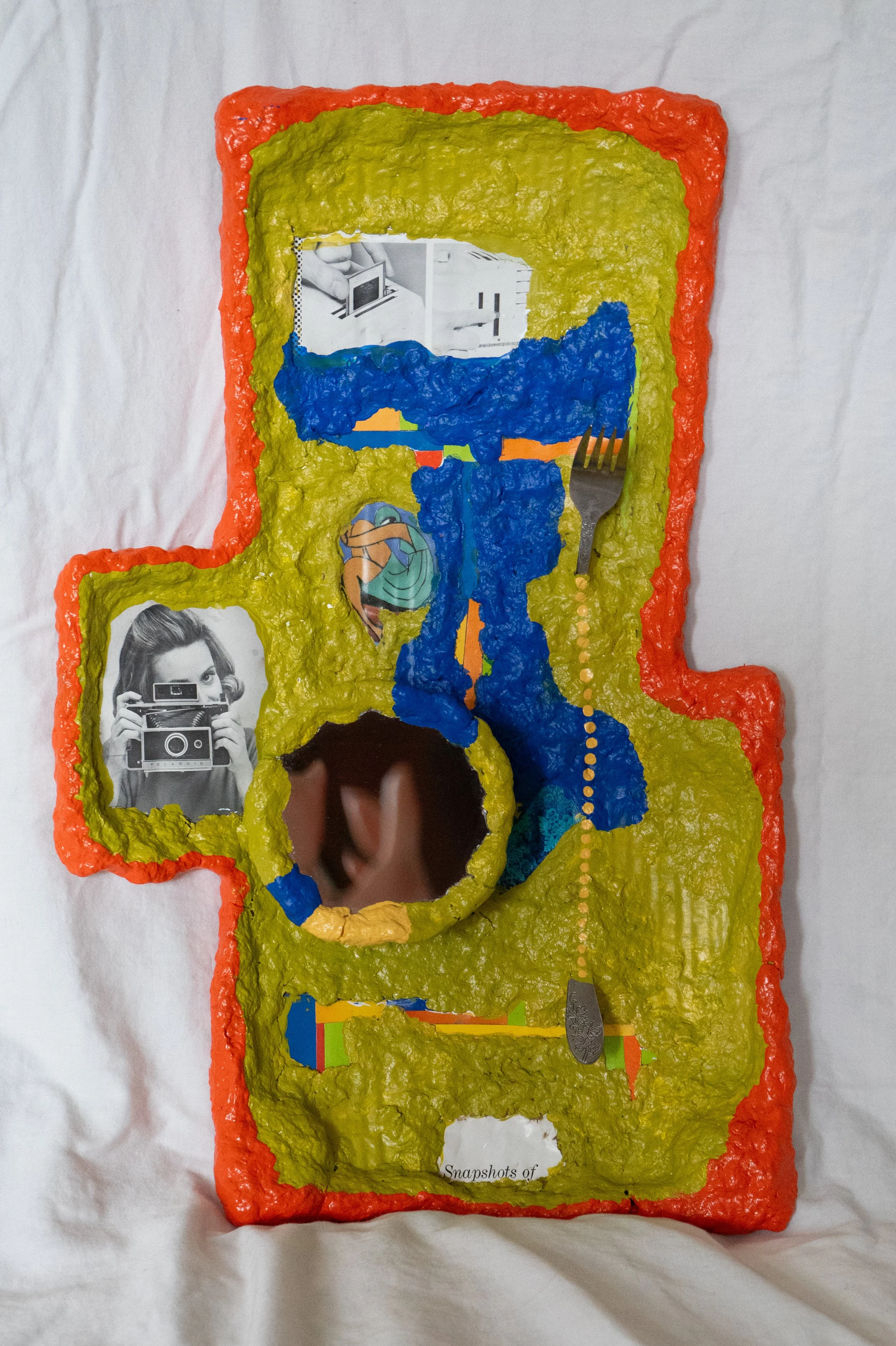 cardboard, repurposed mirror, broken fork, various paper cutouts