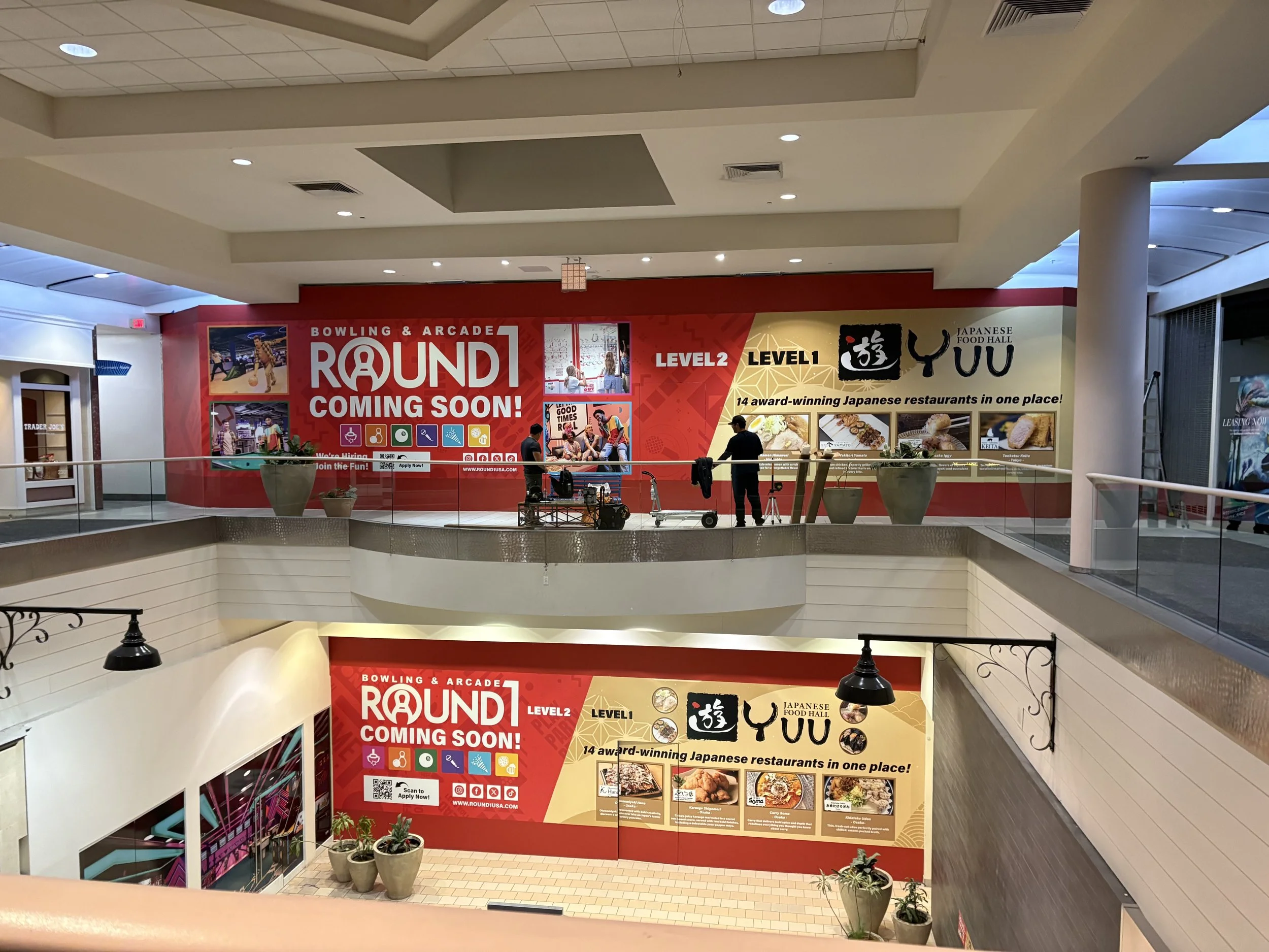 Large-format barricade graphics installed for a new Round1 retail location inside a Southern California shopping mall