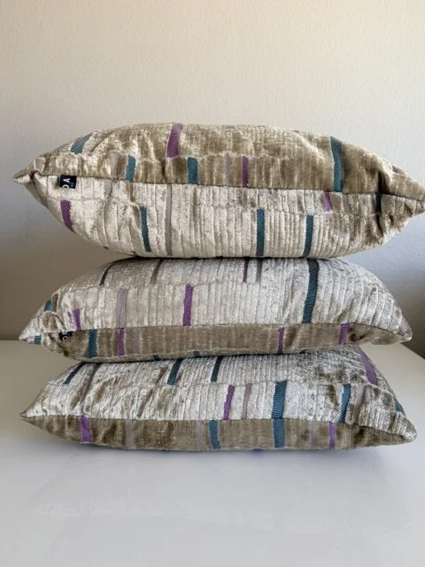 Three 20" x 20" champagne, pink and turquoise pillows