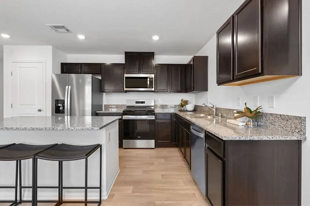 Kitchen with granite island and stainless appliances