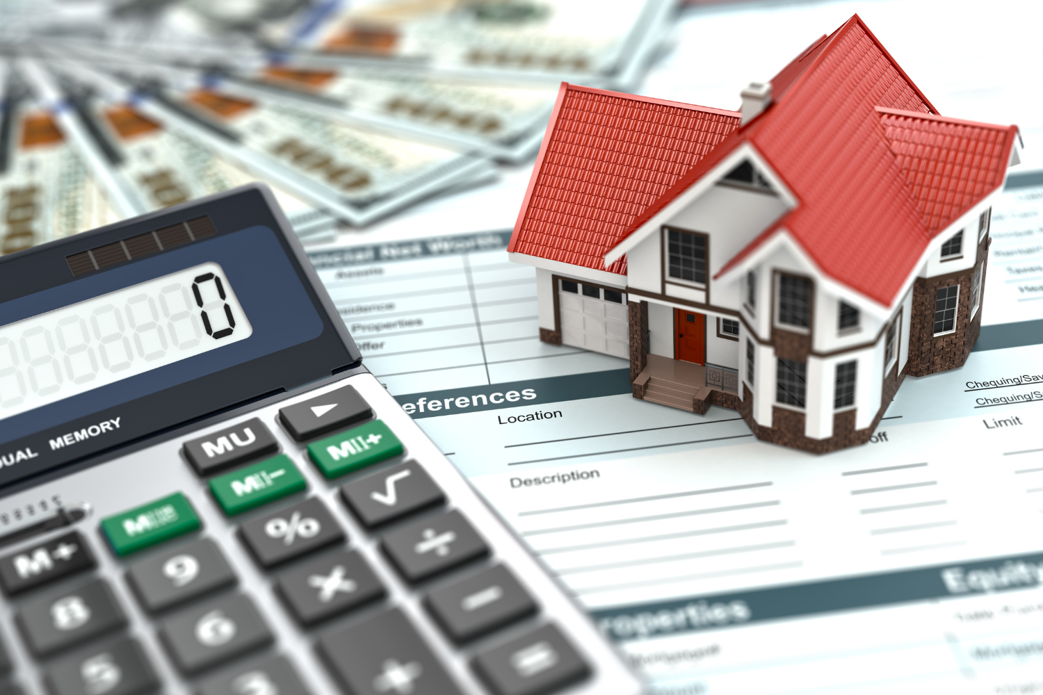 A miniature house model, a calculator, and financial documents on a table, representing real estate and mortgage planning.
