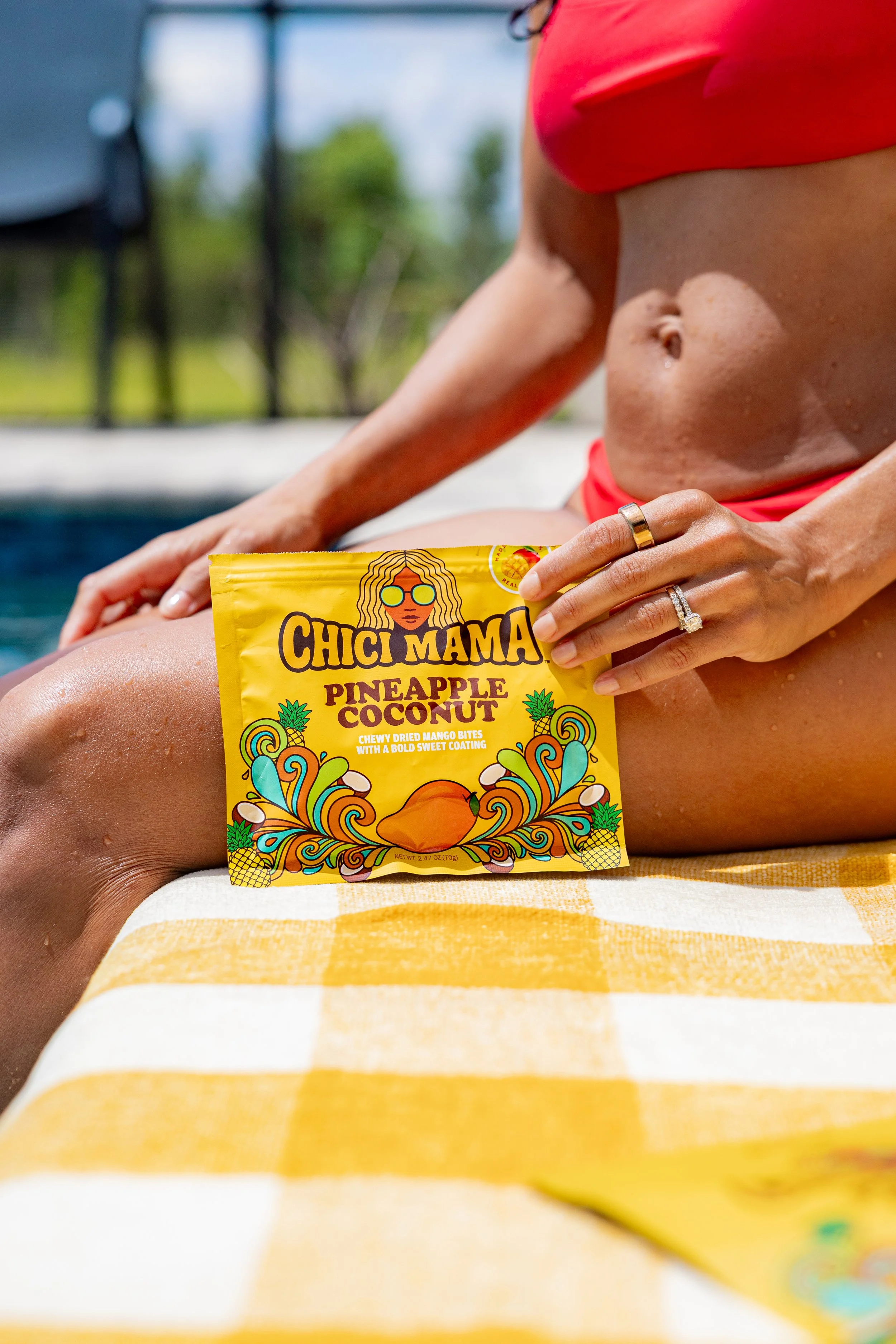 Chici Mama Pineapple Coconut bag on yellow striped beach towel, close-up product lifestyle photography by Gabe Gonzalez