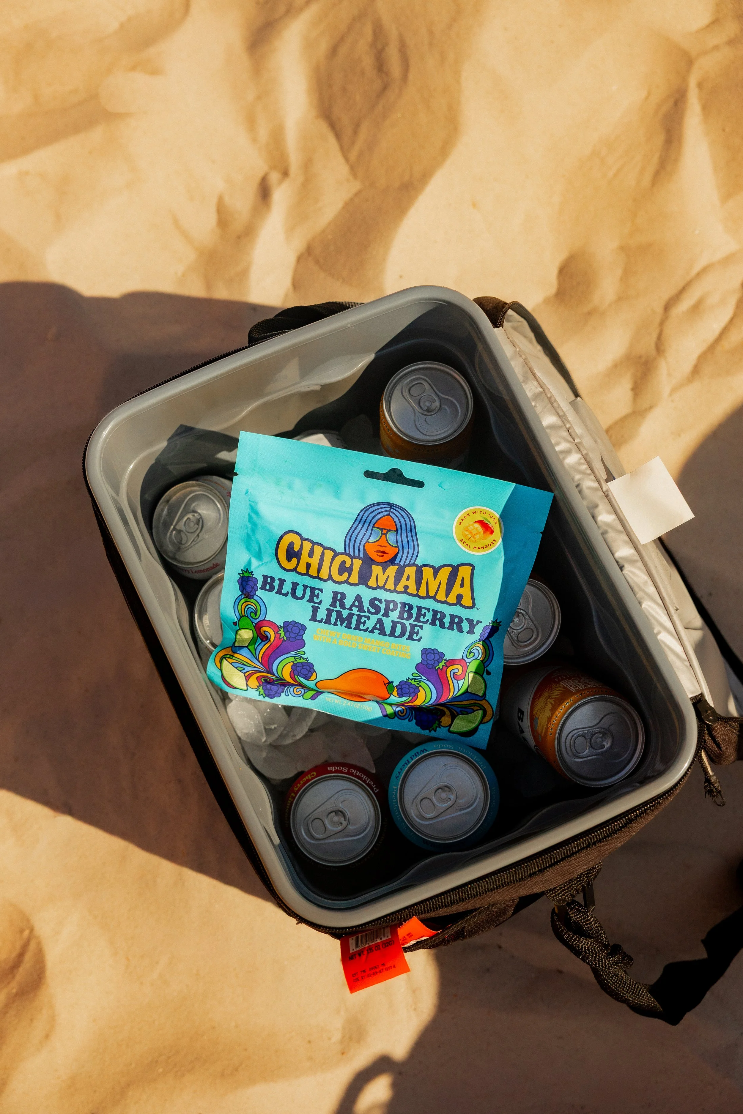 Chici Mama Blue Raspberry Limeade bag in cooler with canned drinks, summer snack brand photography by Gabe Gonzalez