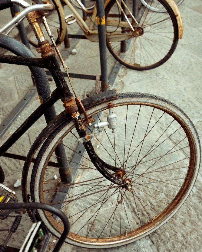 Weathered by time and kissed by rust these bicycles seemed to hold quiet stories of countless rides through the cobblestone streets of Florence and sunlit piazzas. 

I was drawn to the texture and the patina, capturing a moment of stillness and histo