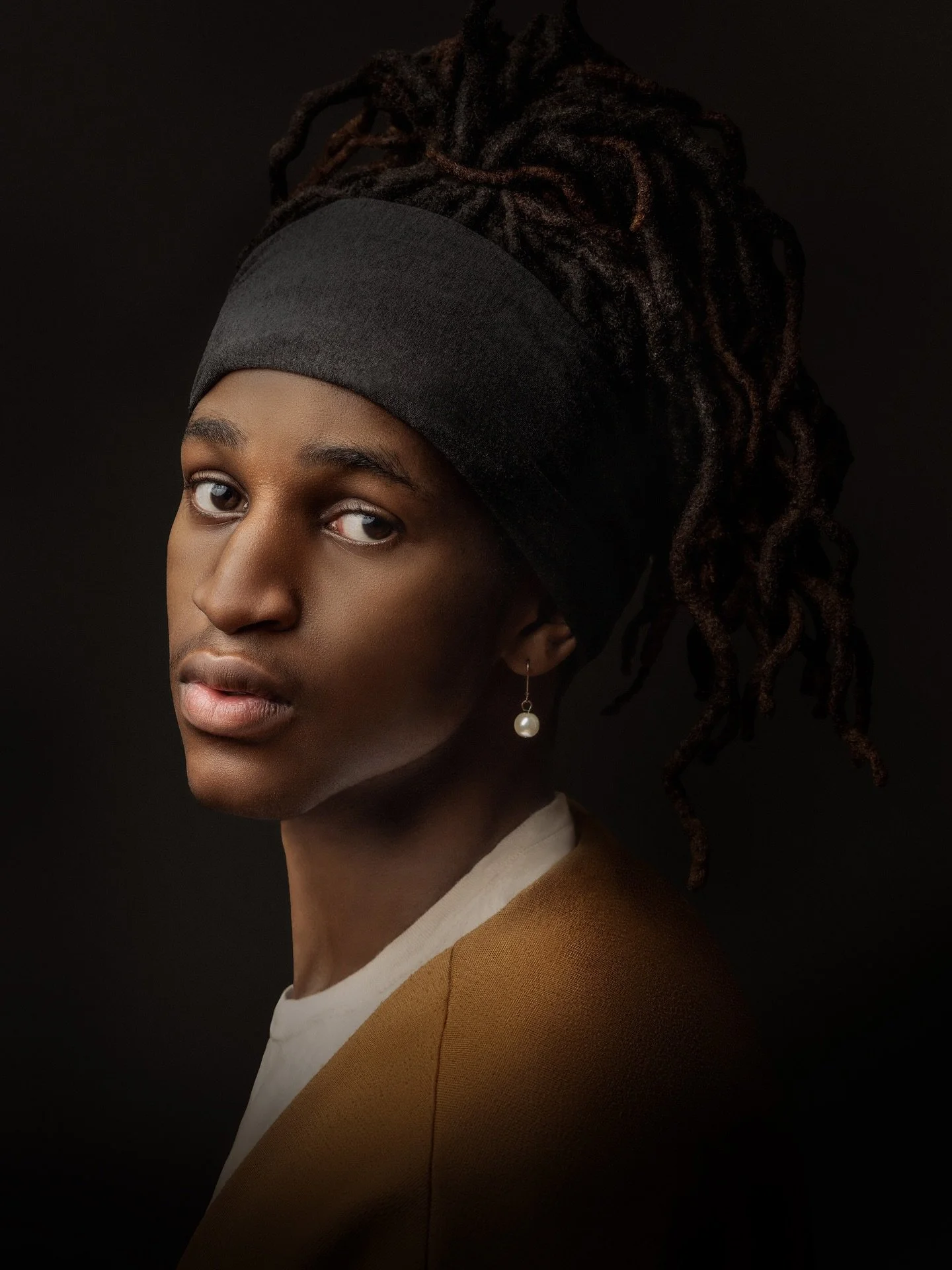 This portrait draws inspiration from the timeless painting of Girl with a Pearl Earring by Johannes Vermeer. In my reinterpretation, I set out to honor the essence of the original while reimagining it through a contemporary and more inclusive lens.

