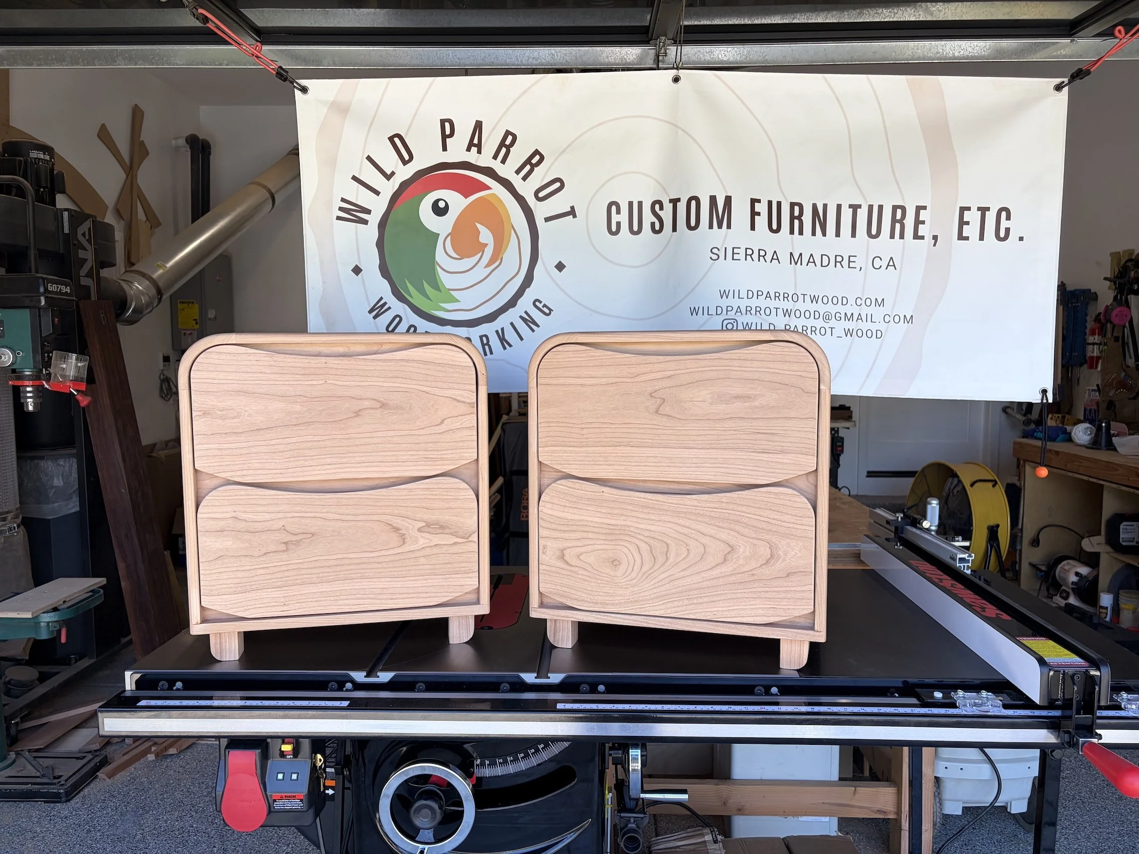 Matching cherry nightstands with built-in wifi charging.