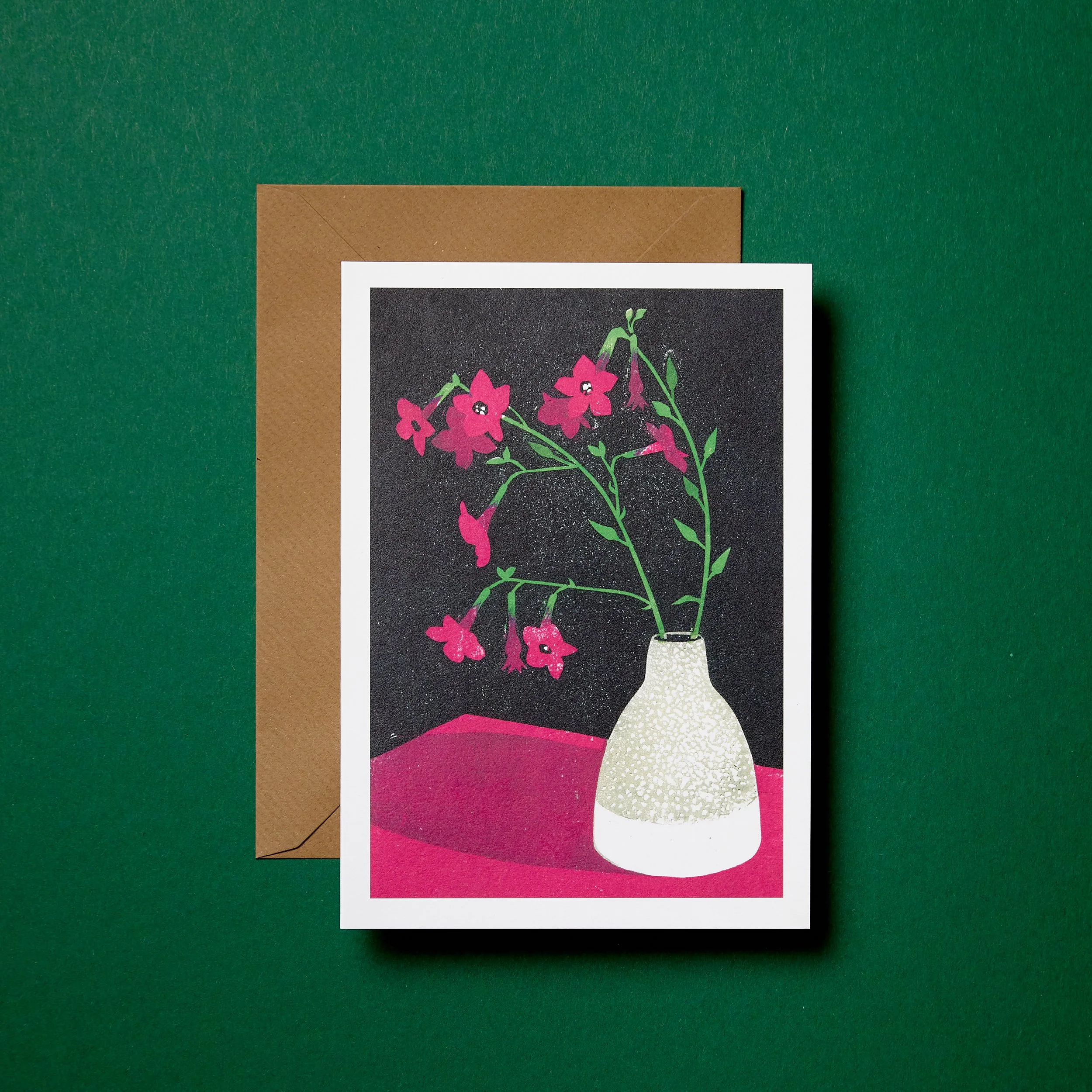 Greeting card with illustration of pink flowers in a white vase on a pink and green background.