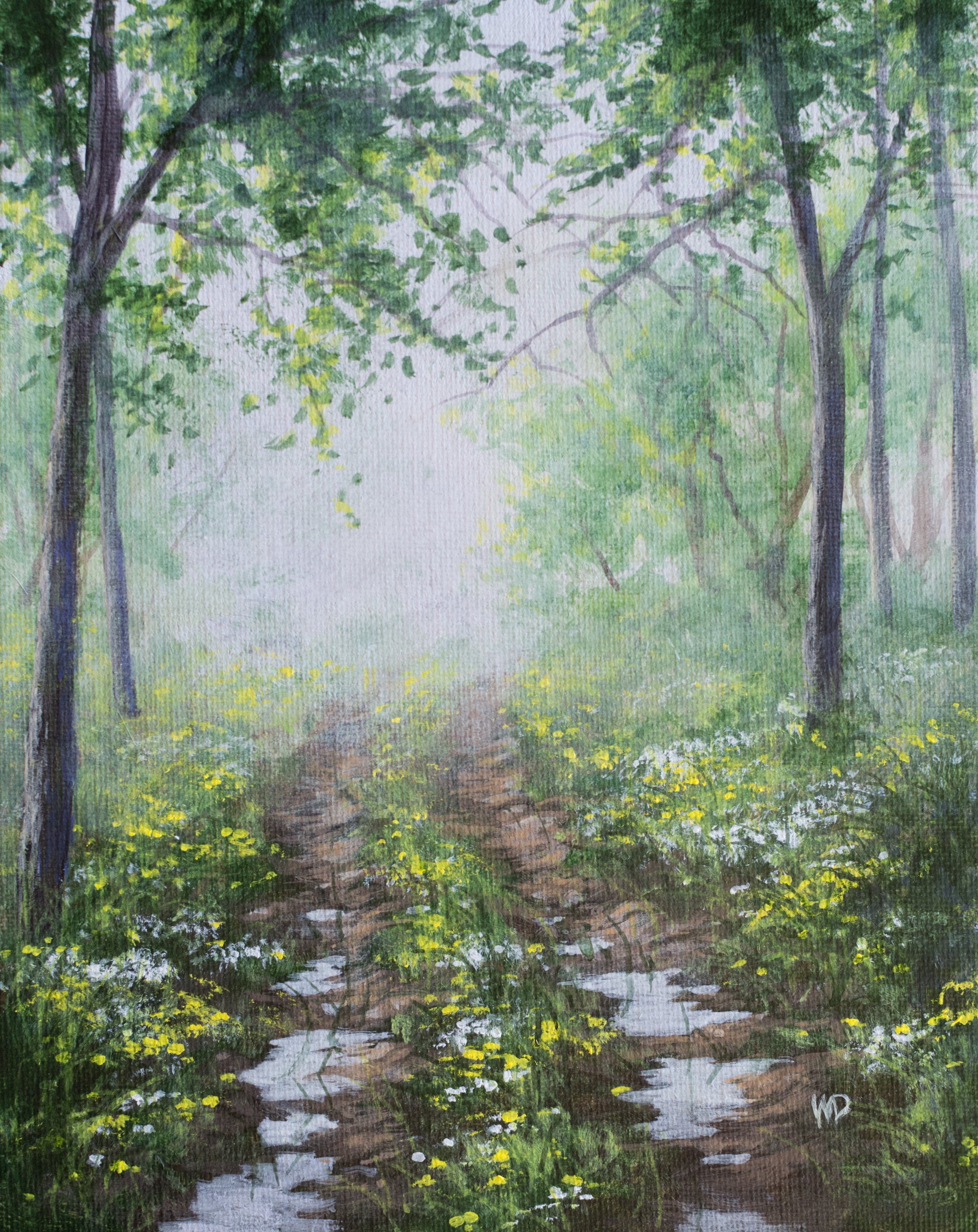 puddles in muddy track through flowers grass and trees