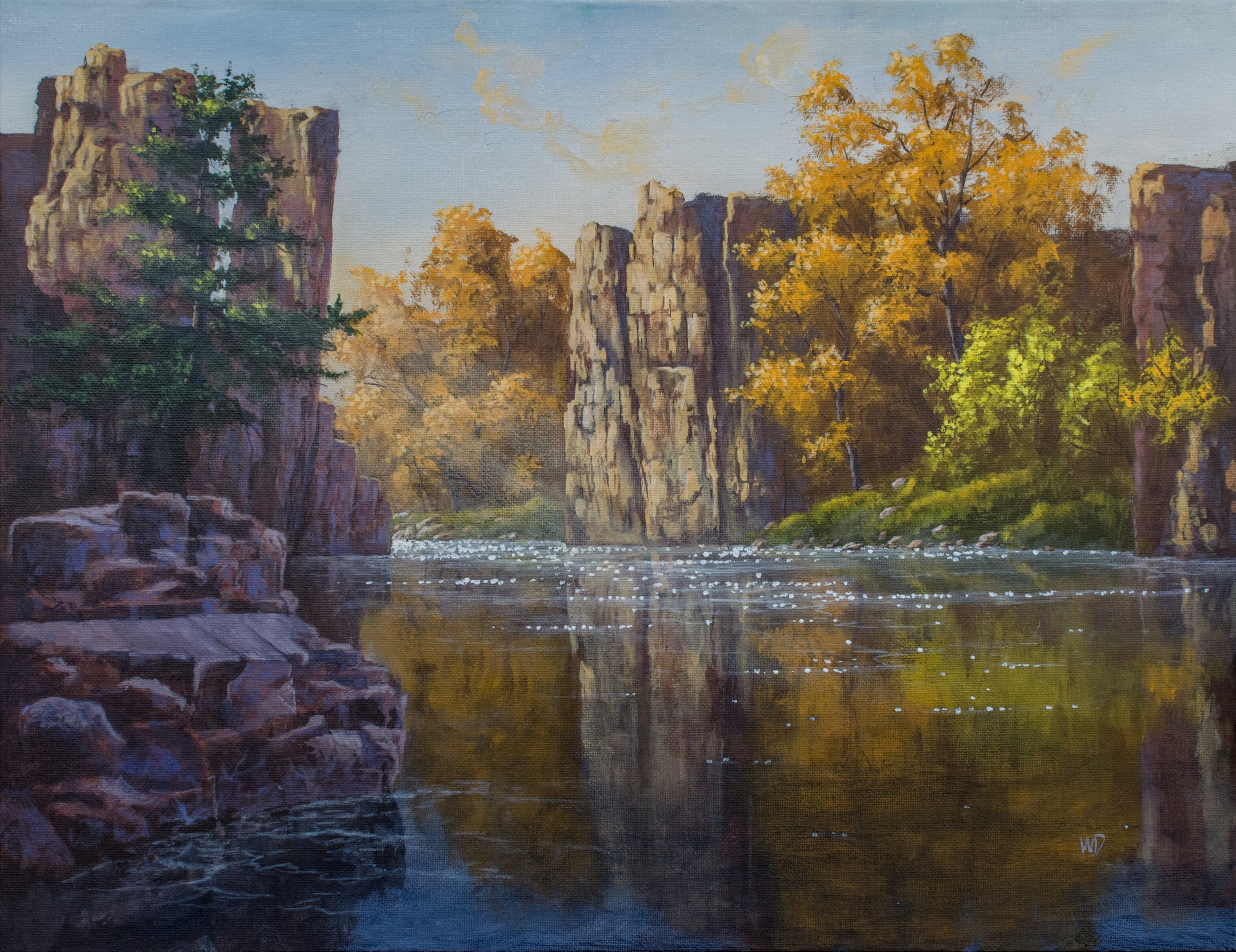 cliffs over river orange tree reflected in water pink rocks
