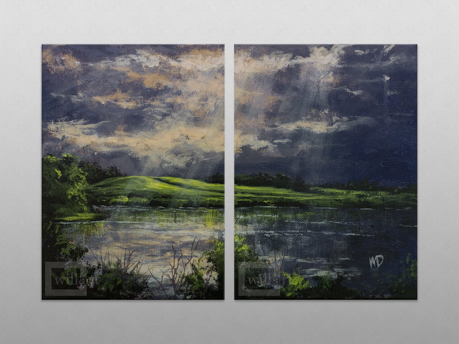 gentle sun streams down between clouds on green hill and calm lake