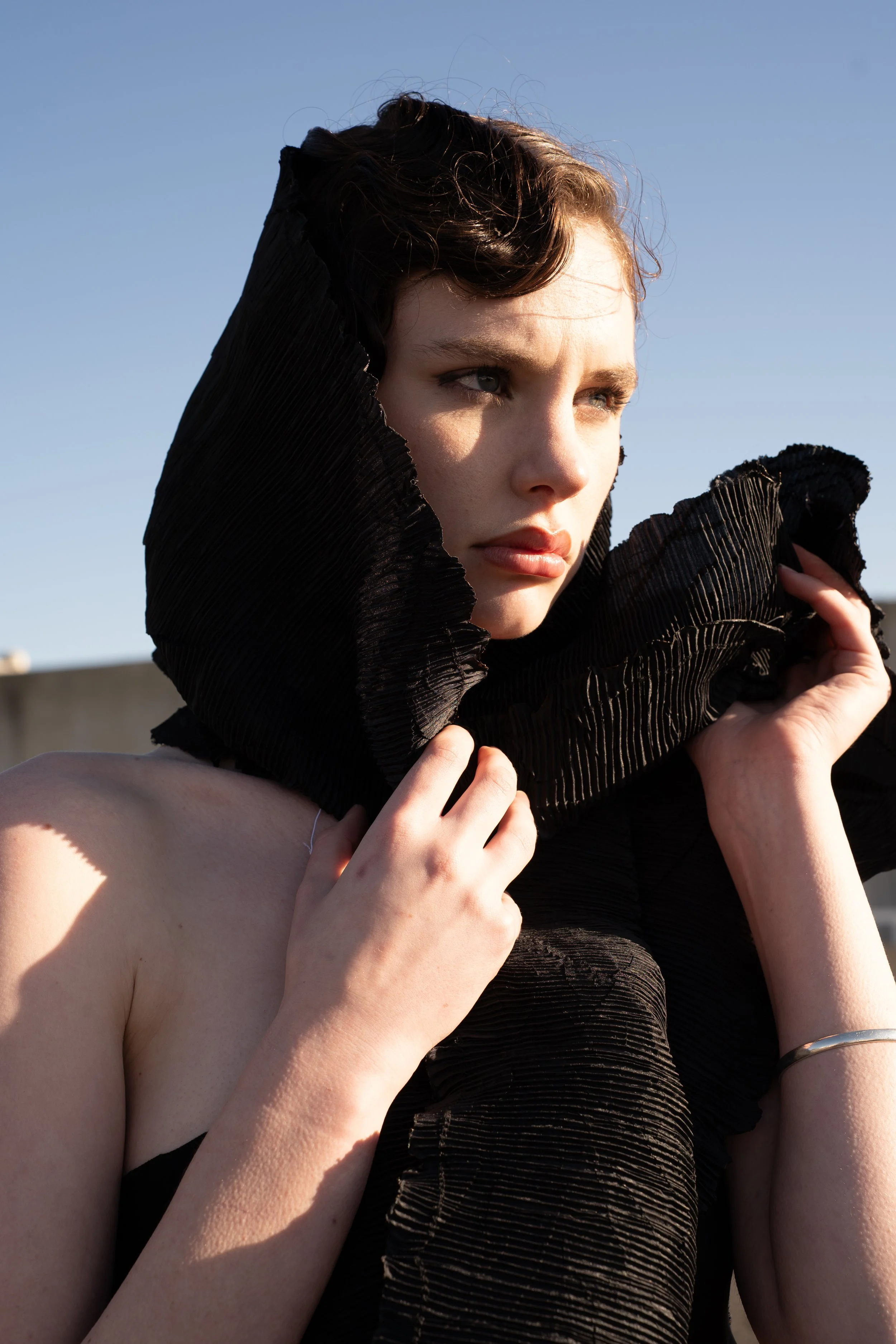 Black mesh handbag with chain strap and border detail.