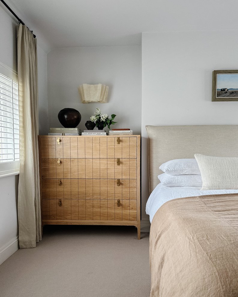 Bedroom with curated collection of artisan cushions